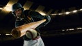 Poster with professional baseball player with baseball bat in action during match in crowed sport stadium at evening Royalty Free Stock Photo