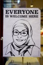 Poster representing a Muslim woman with a hijab veil saying Everyone is Welcome Here