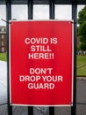 A poster sign to remind people that `Covid is still here, don`t drop your guard`