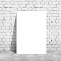 Poster standing next to a brick wall Royalty Free Stock Photo
