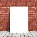 Poster standing next to a brick wall Royalty Free Stock Photo