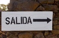 Poster with the word exit in Spanish and an arrow