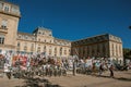 Posters of theatrical plays affixed to a building grid in the city center of Avignon.