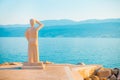 POSTIRA, CROATIA - JULY 12, 2017: Famous stone monument of person looking into a horizon in a small town Postira - Croatia, island