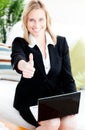 Postive businesswoman with thumb up using a laptop Royalty Free Stock Photo