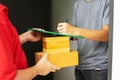 Postman delivering package of goods to home. Selective focus on the hands. Home delivery concept, Deliver packages to recipients Royalty Free Stock Photo