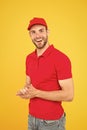 Postman delivery worker. Man red cap yellow background. Delivering purchase. Already ready. Easing your business