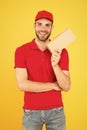 Postman delivery worker. Man red cap yellow background. Delivering purchase. Delivering happiness and needs. Super fast