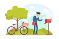 Postman Putting Letter in Mailbox, Mailman in Blue Uniform Delivering Mails to Customers on Bike, Delivery Service Royalty Free Stock Photo