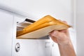 Postman putting letters in mailbox Royalty Free Stock Photo