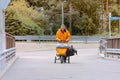 Postman in uniform with bag and cart, delivering Royalty Free Stock Photo