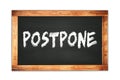 POSTPONE text written on wooden frame school blackboard