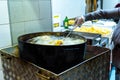 Pot with boiling oil to prepare the typical Polenta Gialla, boiled corn flour, traditional from Italy and countries of South