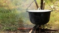 Pot of boiling Ukha (fish-soup) on the campfire