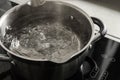 Pot with boiling water on electric stove in kitchen Royalty Free Stock Photo