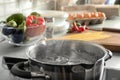 Pot with boiling water on electric stove in kitchen Royalty Free Stock Photo