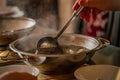 Pot with chicken soup vegetables in pot hot plate arm man Royalty Free Stock Photo