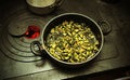 Pot with cooked zucchini in the ancient stove with fire lit Royalty Free Stock Photo