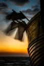 Pot flags blow in the wind on a fishing boat at dawn