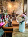 Pot with flowers on the tables in vintage cafe, luxuary interior. Cafe table, empty , no people