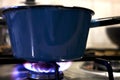 Pot on the gas stove with blue flamme at the kitchen Royalty Free Stock Photo