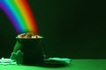 Pot with gold coins and clover leaves on table, space for text. St. Patrick`s Day celebration