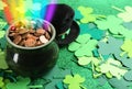 Pot with gold coins, hat and clover leaves on table, space for text. St. Patrick`s Day celebration Royalty Free Stock Photo