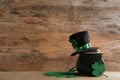 Pot of gold coins, hat and clover leaves on wooden table, space for text. St. Patrick`s Day celebration Royalty Free Stock Photo
