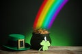 Pot with gold coins, hat and clover on table against dark background, space for text. St. Patrick`s Day Royalty Free Stock Photo