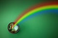 Pot with gold coins and rainbow on green background. St Patrick's day celebration. Royalty Free Stock Photo