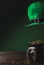 Pot with golden coins, horseshoe and green hat Royalty Free Stock Photo