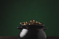 pot of golden coins on wooden table on green st patricks