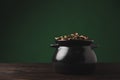 pot of golden coins on wooden table st patricks