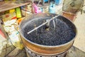 Pot with hot pebbles to roast chestnuts, street food in Chinatown, Kuala Lumpur