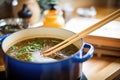 pot of lentil soup with a wooden stirring spoon