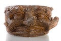 Pot made of clay in the shape of the face in tree trunks on whit