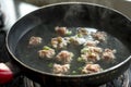 A pot of pork meatball soup being cooked Royalty Free Stock Photo