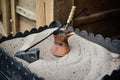 Pot for preparation of turkish coffee on hot sand Royalty Free Stock Photo