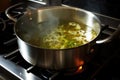 a pot of soup boiling and bubbling on a gas stove