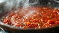 Pot of tomato sauce simmering on the stove, with steam rising from the pot. Nice texture and deep red color.