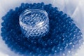 Pot of transparent balls on blue water gel balls with bokeh. Polymer gel Silica gel. Blue hydrogel balls. Liquid crystal ball with