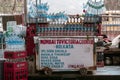 A potable mobile outdoor market vendor food stall display with soda water, soft drinks and water bottles in a roadside eatery in