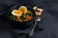 Potaje de Garbanzos chickpea stew Spanish recipe traditional with ingredients on a dark background with copy space