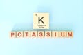 Potassium chemical element symbol with atomic mass and atomic number in wooden blocks flat lay composition. Royalty Free Stock Photo