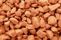 Potassium chloride is a red mineral fertilizer close-up. Red background of fertilizer potassium chloride. Texture of granular