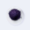 Potassium permanganate on chemical watch glass. KMnO4, a common chemical compound that combines manganese oxide ore with potassium