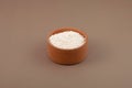 Potassium sorbate, granular potassium salt of sorbic acid in wooden bowl, selective focus. Food additive E202. Potassium sorbate