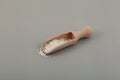 Potassium sorbate, granular potassium salt of sorbic acid in wooden scoop. Food additive E202 used in preparation of syrup and