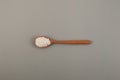 Potassium sorbate, granular potassium salt of sorbic acid in wooden spoon, top view. Food additive E202. Potassium sorbate used as