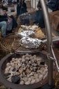 Potato in alumnium foil baked on charcoal barbecue grill outdoor Royalty Free Stock Photo